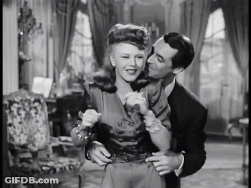 Man Kissing Woman On Cheek Black And White GIF