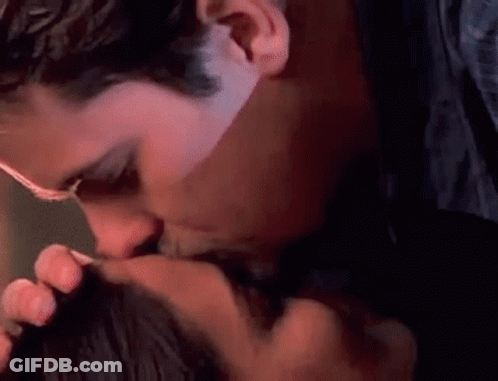 Man Kissing Woman On Cheek GIF
