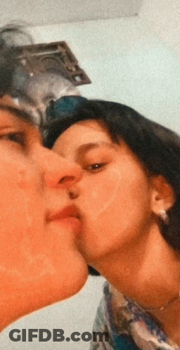 Man Kissing Woman On Cheek GIF