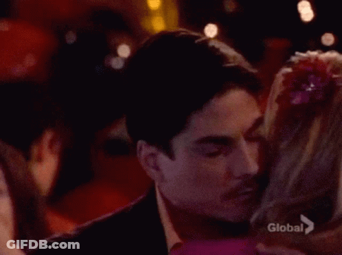 Man Kissing Woman On Cheek Saying Global GIF