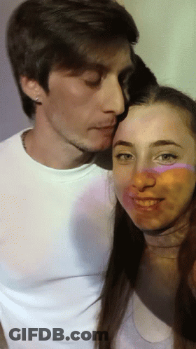 Man Kissing Woman On Cheek While Posing GIF