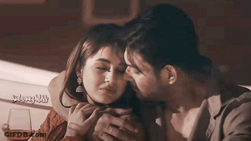 Man Kissing Woman On Forehead Holding Wine GIF