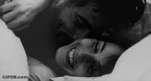 Man Kissing Woman On Forehead In Bed GIF