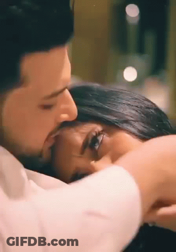 Man Kissing Woman On Forehead In Bed GIF
