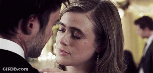 Man Kissing Woman On Forehead In Room GIF