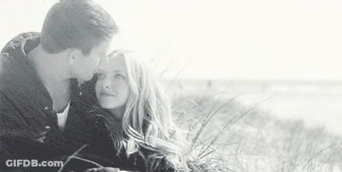 Man Kissing Woman On Forehead On Beach GIF
