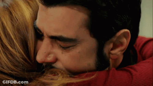 Man Kissing Woman On Forehead While Hugging GIF