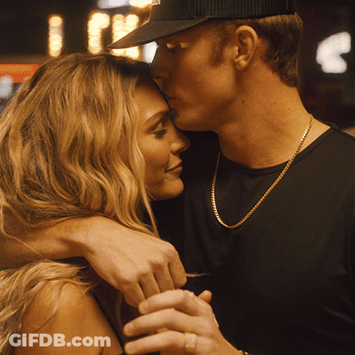 Man Kissing Woman On Forehead With NYC Hat GIF