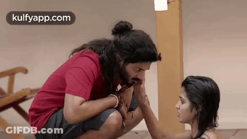 Man Kissing Woman's Hand While Sitting GIF