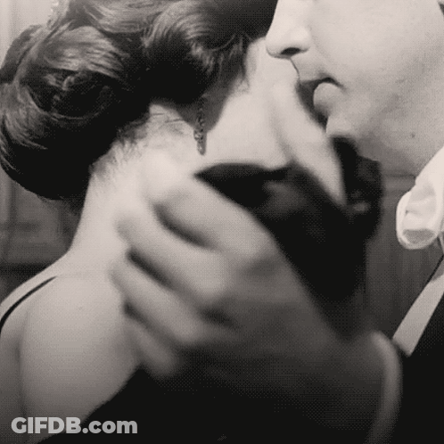 Man Kissing Woman's Neck Black And White GIF