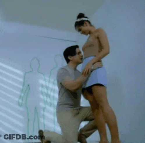 Man Kneeling And Kissing Woman's Leg GIF