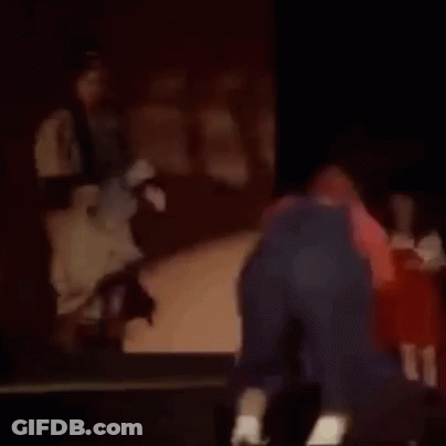 Man Kneeling At Piano With Woman Behind GIF