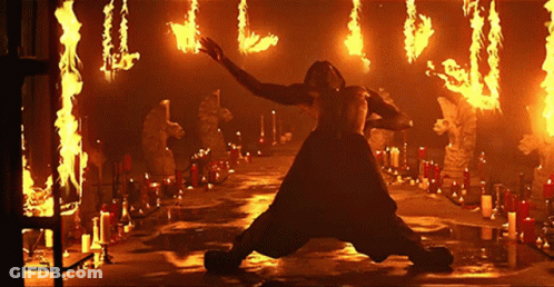 Man Kneeling Before Flames And Candles GIF