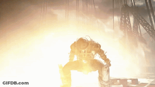 Man Kneeling Before Large Fire GIF