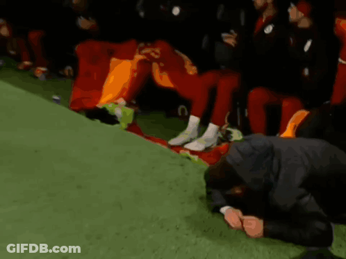 Man Kneeling Before Soccer Players Number 23 GIF