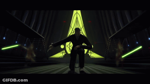 Man Kneeling Before Yellow Triangle GIF