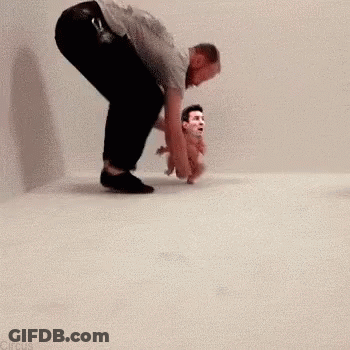 Man Kneeling Beside Baby With Man's Face Picture GIF