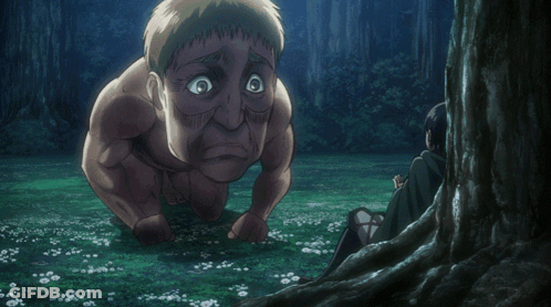 Man Kneeling Beside Tree While Another Sits In Grass GIF
