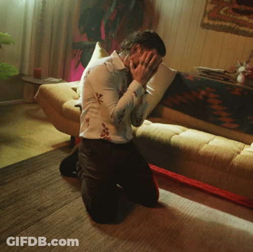 Man Kneeling Covering Face GIF
