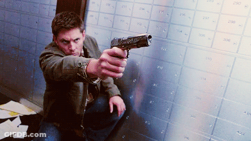 Man Kneeling Holding Gun GIF