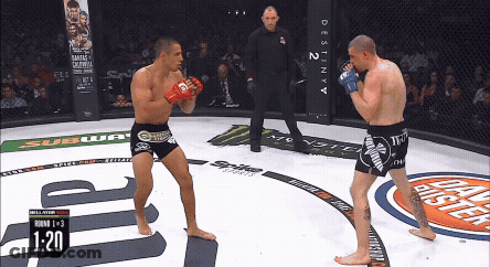 Man Kneeling In Boxing Ring With Another Man Standing Behind GIF