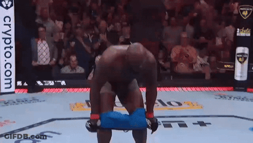 Man Kneeling In Boxing Ring With Crypto.com Ad GIF