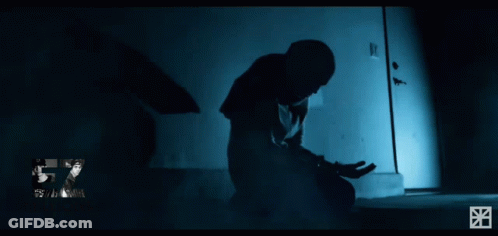 Man Kneeling In Front Of Door With Psycho Sticker GIF