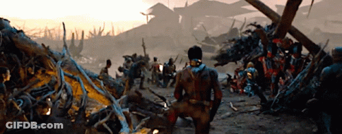 Man Kneeling In Front Of Group In Destroyed Area GIF