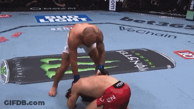 Man Kneeling In Front Of Monster Energy Drink Advertisement GIF