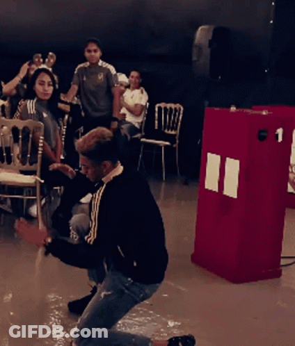 Man Kneeling In Front Of Red Box Number 1 GIF