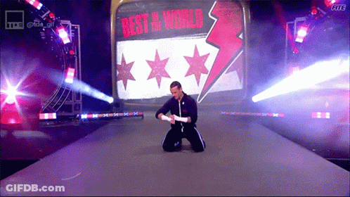 Man Kneeling In Front Of Sign Best In World GIF