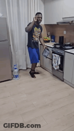 Man Kneeling In Kitchen With Aquafina Water GIF