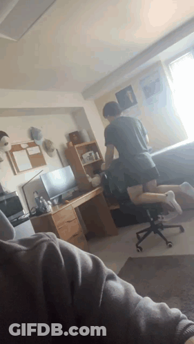 Man Kneeling In Room With Desk And Chair GIF