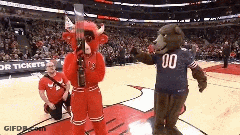 Man Kneeling Next To Mascot In 00 Jersey GIF