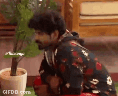Man Kneeling Next To Potted Plant GIF