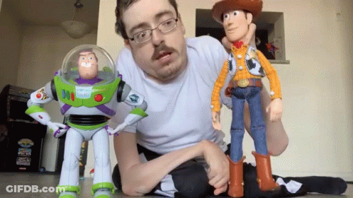 Man Kneeling Next To Toy Story Buzz Lightyear And Woody GIF