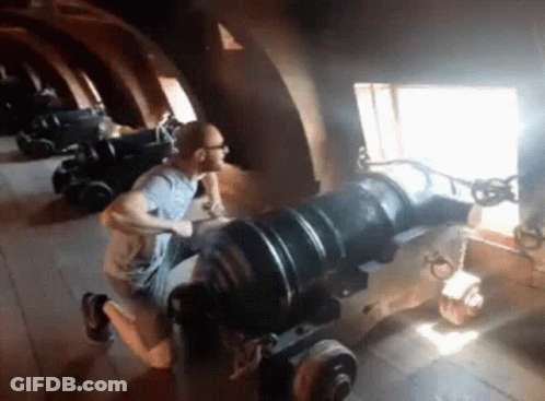 Man Kneeling On Cannon GIF