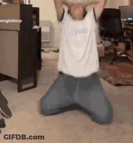 Man Kneeling On Floor With Arms Outstretched GIF