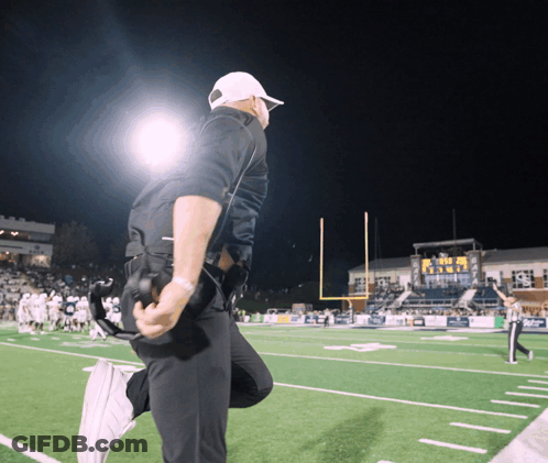 Man Kneeling On Football Field Saying Texas GIF
