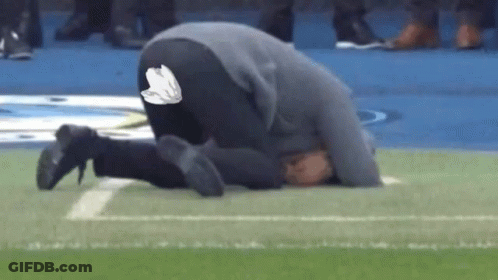 Man Kneeling On Football Field GIF