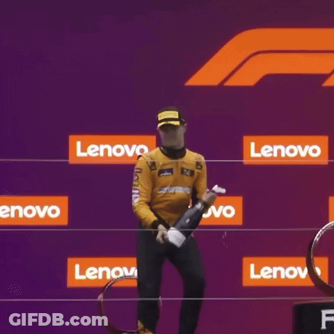 Man Kneeling On Podium With Lenovo Sign GIF