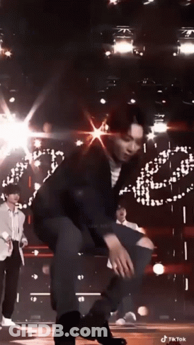 Man Kneeling On Stage In Front Of Crowd GIF