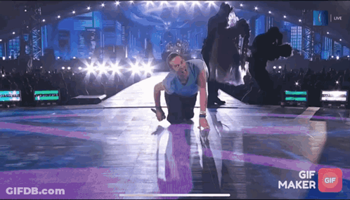 Man Kneeling On Stage With GIF Maker App GIF