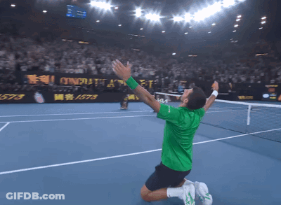 Man Kneeling On Tennis Court Arms In Air GIF