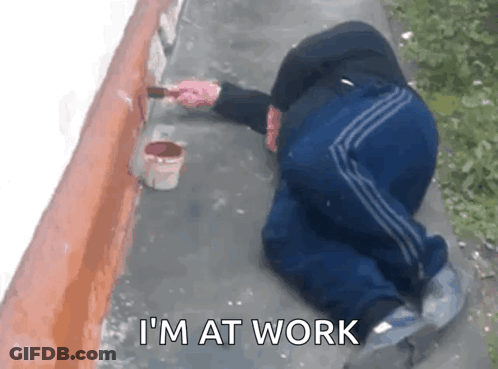 Man Kneeling Painting Wall Saying I'm At Work GIF