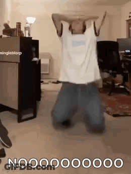 Man Kneeling With Arms Outstretched In Living Room GIF