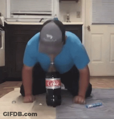 Man Kneeling With Coke Bottle GIF
