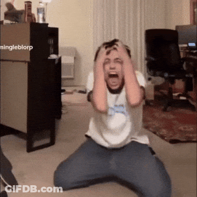 Man Kneeling With Hands On Head In Front Of Ningleblorp Box GIF