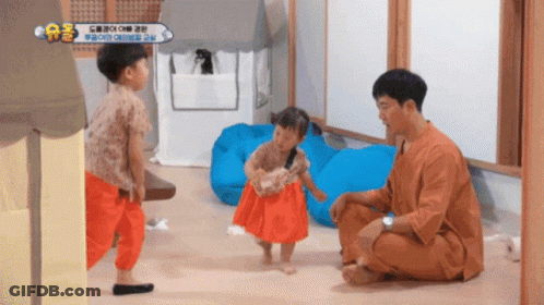 Man Kneeling With Two Little Girls And AE Sign GIF