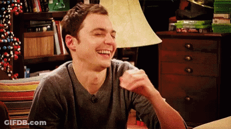 Man Laughing At Table With Lamp GIF